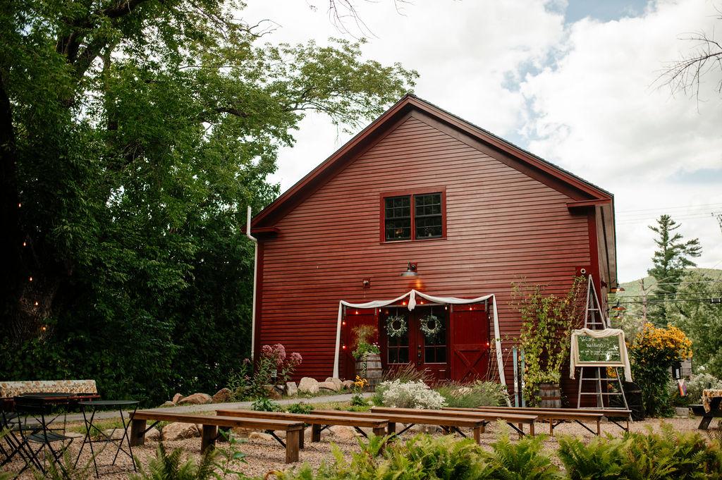 Rustic wedding reception decor inside the Alpine Garden barn
