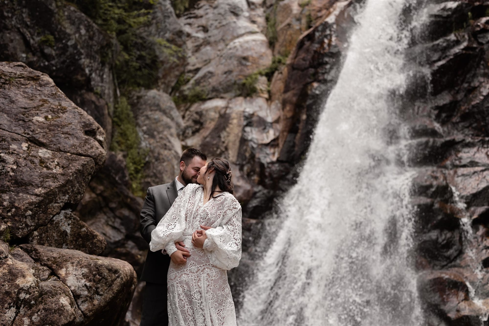 Bride and groom at an off-site waterfall ceremony coordinated by Alpine Garden